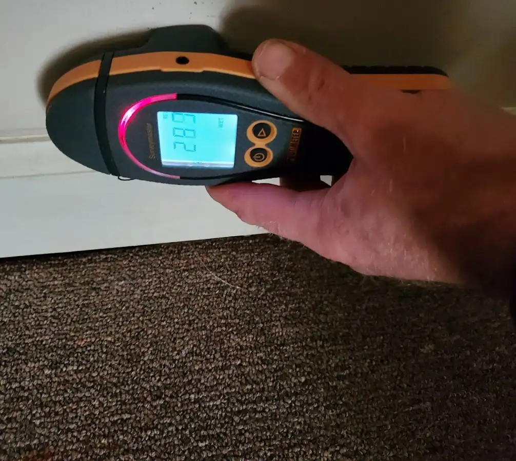 Moisture detection at baseboard during Storm Damage Restoration in Jefferson